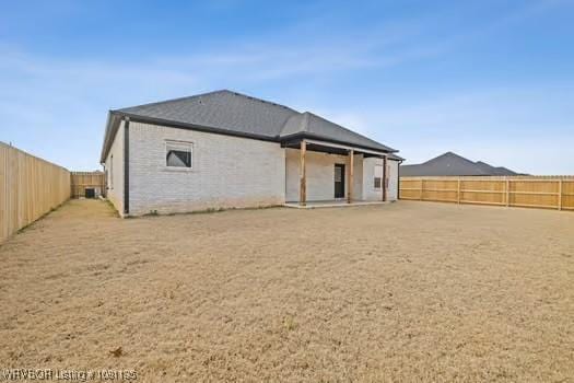 2018 Yellowstone Dr, Barling, AR 72903 - rear view of house with a fenced backyard