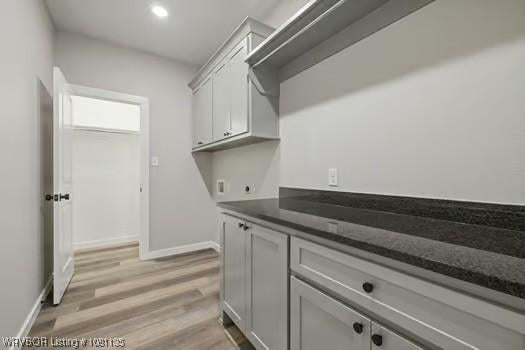 2018 Yellowstone Dr, Barling, AR 72903 - laundry area with hookup for an electric dryer, baseboards, light wood finished floors, cabinet space, and recessed lighting