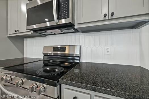 2018 Yellowstone Dr, Barling, AR 72903 - kitchen with appliances with stainless steel finishes, decorative backsplash, and white cabinets