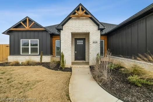 2018 Yellowstone Dr, Barling, AR 72903 - view of front of home featuring board and batten siding and brick siding