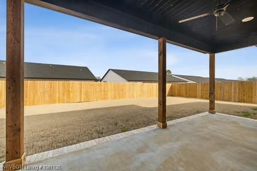 2018 Yellowstone Dr, Barling, AR 72903 - fenced backyard with ceiling fan and a patio area