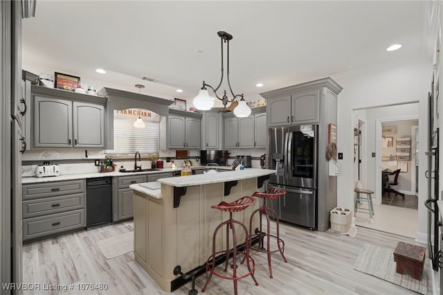 kitchen with pendant lighting, gray cabinets, light hardwood / wood-style floors, a kitchen island, and stainless steel fridge with ice dispenser