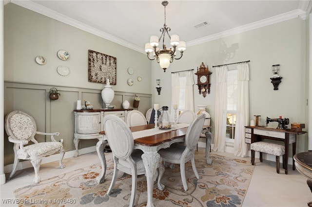 dining room featuring an inviting chandelier and ornamental molding