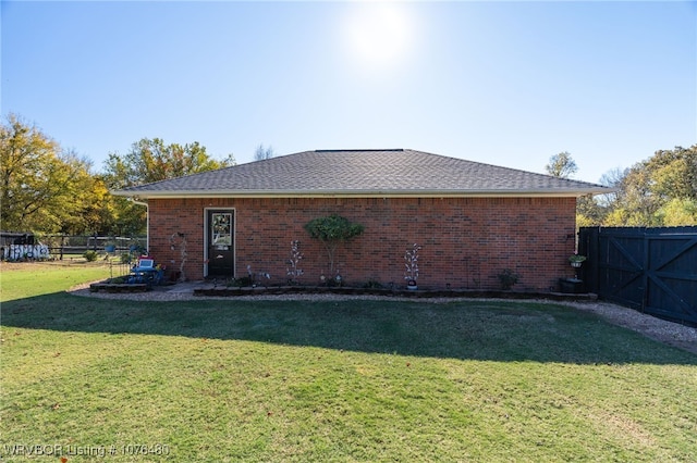 rear view of property with a lawn