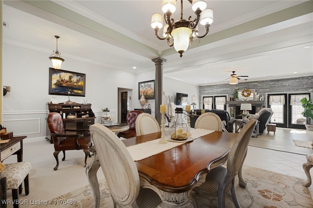 dining room featuring ceiling fan with notable chandelier, decorative columns, and crown molding