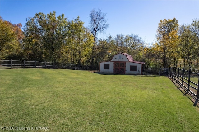 view of yard featuring a rural view and an outdoor structure