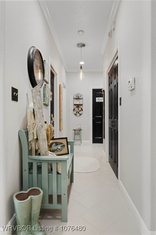 hallway featuring tile patterned flooring and crown molding