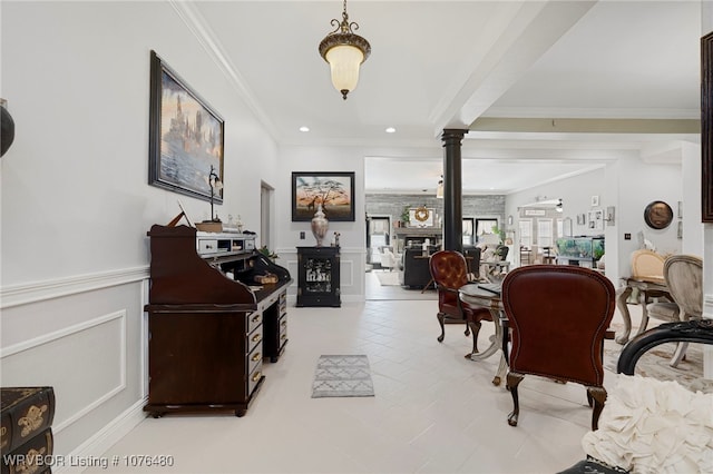 interior space featuring decorative columns and crown molding