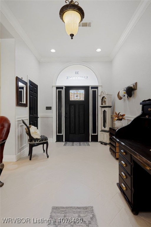 tiled foyer entrance with ornamental molding