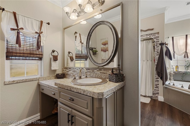 bathroom with a tub, crown molding, hardwood / wood-style floors, decorative backsplash, and vanity