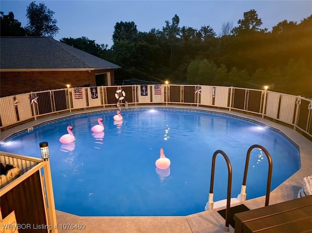 view of pool at dusk