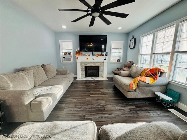 living room featuring baseboards, cooling unit, a ceiling fan, and wood finished floors