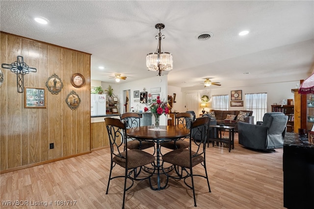 406 Hamilton St, Poteau, OK 74953 - dining room with a ceiling fan, light wood-type flooring, wooden walls, a chandelier, and recessed lighting