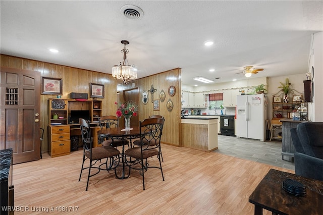406 Hamilton St, Poteau, OK 74953 - dining area with ceiling fan, wooden walls, light wood-style floors, a chandelier, and recessed lighting