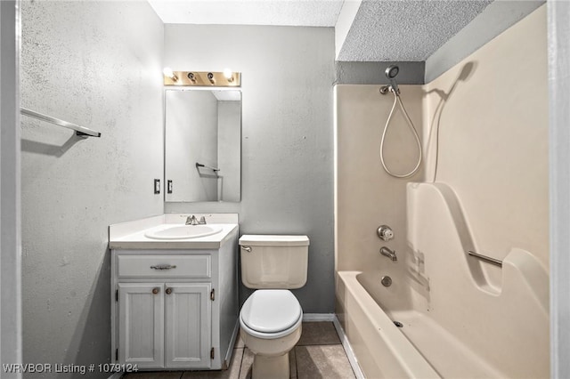 full bath featuring shower / bath combination, toilet, vanity, tile patterned flooring, and baseboards