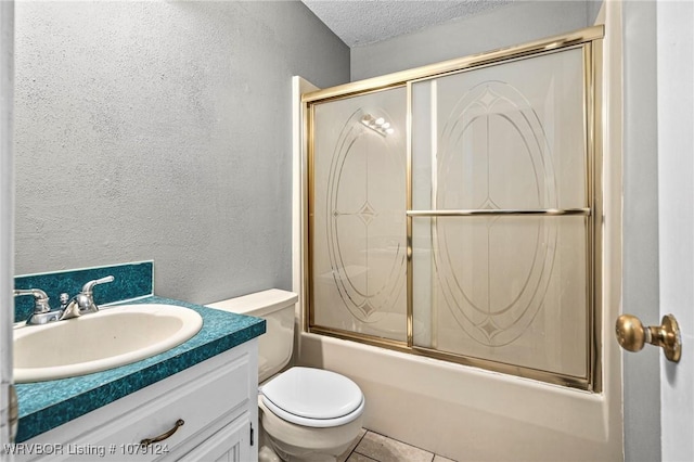 bathroom with bath / shower combo with glass door, a textured wall, toilet, a textured ceiling, and vanity