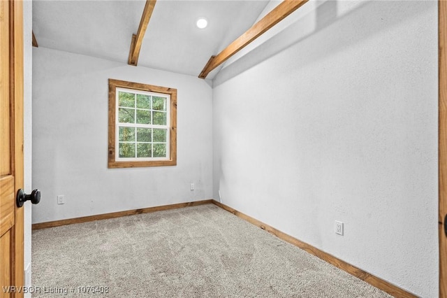 spare room with vaulted ceiling with beams and carpet floors