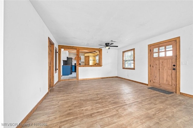 unfurnished living room featuring hardwood / wood-style floors and ceiling fan