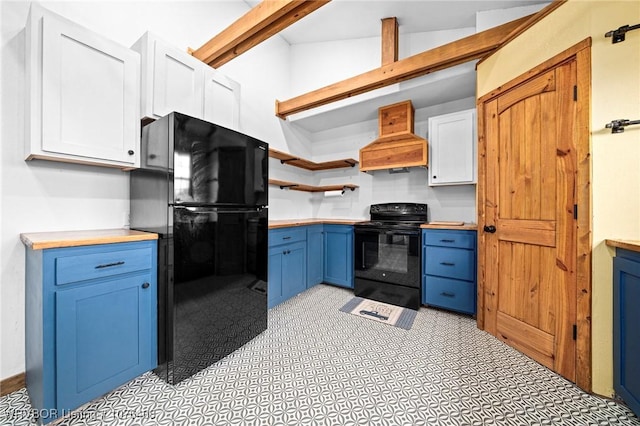 kitchen with custom range hood, vaulted ceiling, black appliances, blue cabinetry, and white cabinets