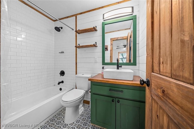 full bathroom featuring tiled shower / bath combo, crown molding, wood walls, toilet, and vanity