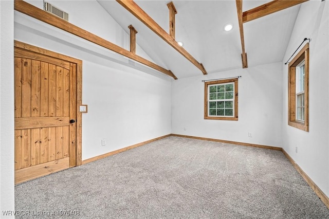 empty room featuring carpet flooring and lofted ceiling with beams