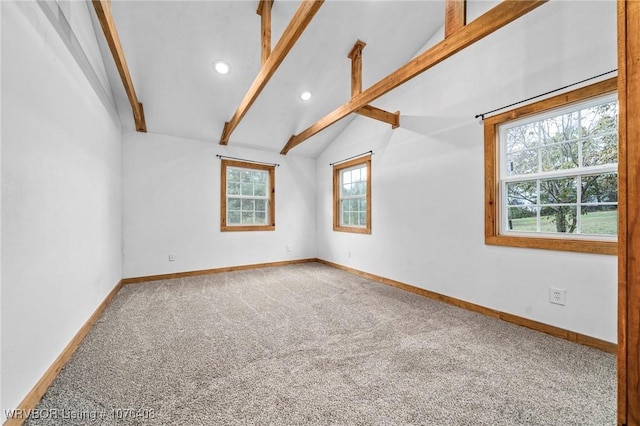 carpeted empty room with vaulted ceiling with beams