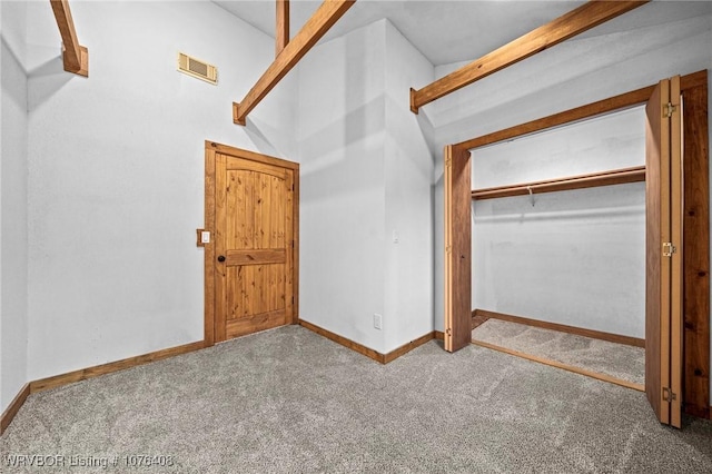 unfurnished bedroom with a closet and carpet floors