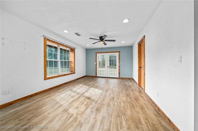 spare room featuring french doors, light hardwood / wood-style flooring, and ceiling fan