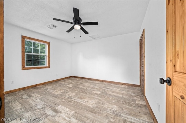 unfurnished room with wood-type flooring, a textured ceiling, and ceiling fan