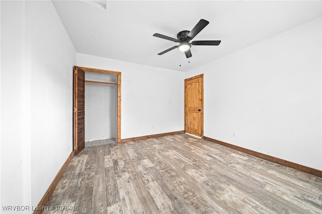 unfurnished bedroom featuring hardwood / wood-style flooring, ceiling fan, and a closet