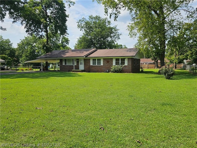 ranch-style home featuring a carport and a front yard