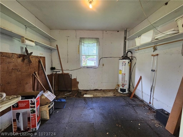 misc room with a workshop area and gas water heater