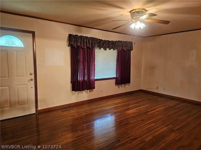 foyer featuring ornamental molding, ceiling fan, and dark wood-type flooring