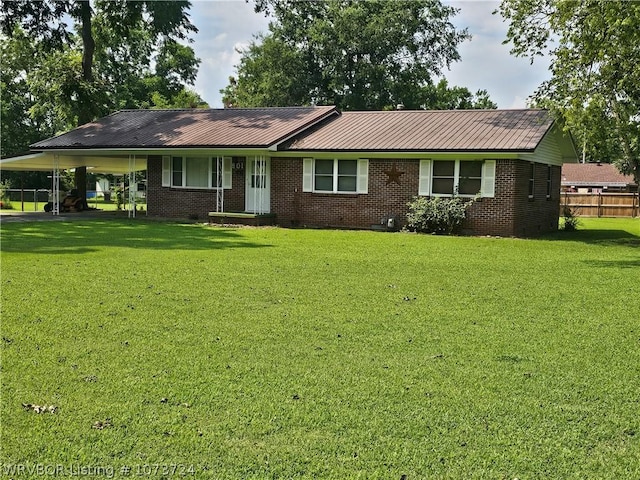 view of front of house with a carport and a front lawn