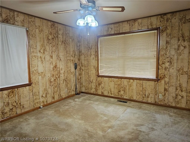 unfurnished room with carpet, ceiling fan, and ornamental molding