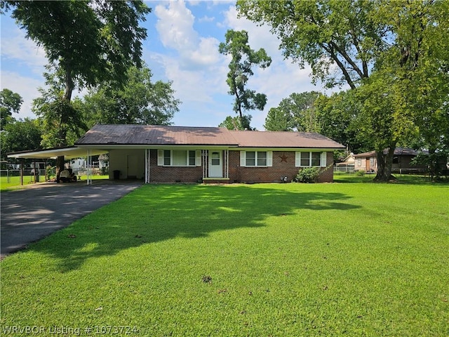 ranch-style home with a front lawn and a carport