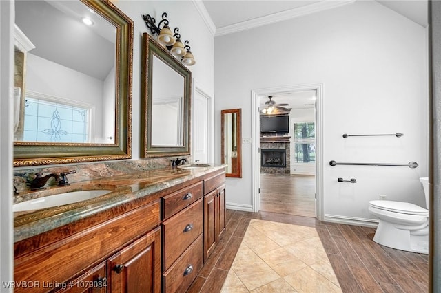 8815 Lakeside Way, Fort Smith, AR 72903 - full bath with vaulted ceiling, a fireplace, a ceiling fan, toilet, and ornamental molding