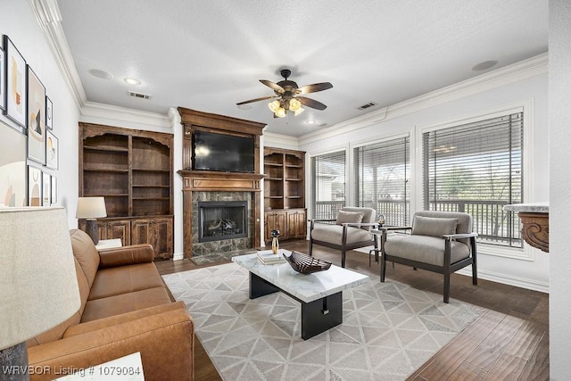 8815 Lakeside Way, Fort Smith, AR 72903 - living area featuring a ceiling fan, ornamental molding, a high end fireplace, and light wood-style flooring