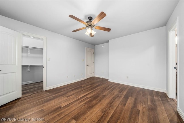 8815 Lakeside Way, Fort Smith, AR 72903 - unfurnished bedroom with dark wood-type flooring, baseboards, a ceiling fan, and a walk in closet