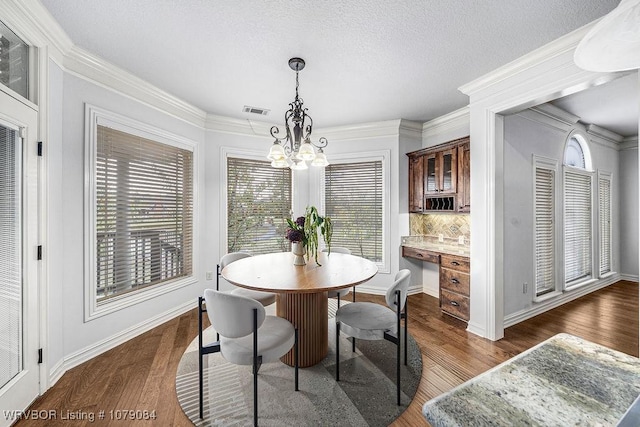 8815 Lakeside Way, Fort Smith, AR 72903 - dining room featuring a chandelier, dark wood-type flooring, ornamental molding, and baseboards