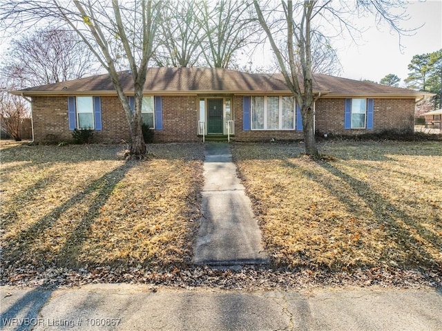 ranch-style house with brick siding and a front lawn