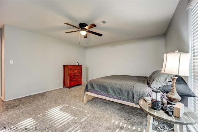 carpeted bedroom with a ceiling fan and baseboards