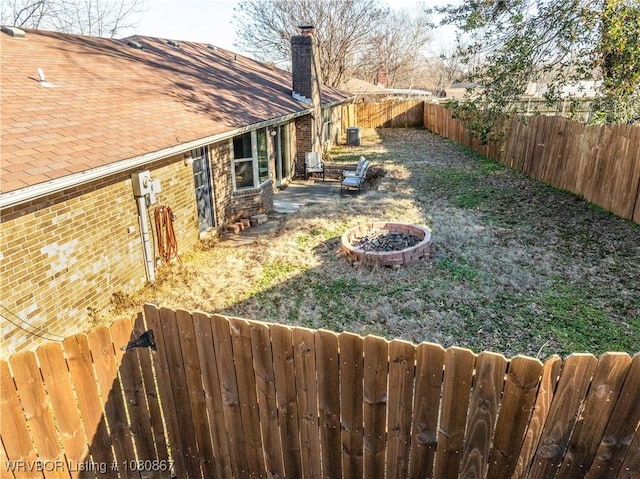 fenced backyard featuring an outdoor fire pit