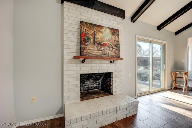 living area featuring a brick fireplace, wood finished floors, and baseboards