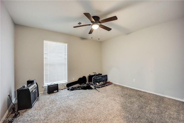 miscellaneous room featuring a ceiling fan, carpet flooring, healthy amount of natural light, and baseboards
