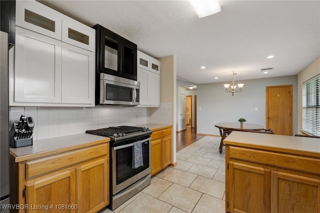 103 Bowlin Dr, Poteau, OK 74953 - kitchen with stainless steel appliances, light countertops, decorative backsplash, and recessed lighting