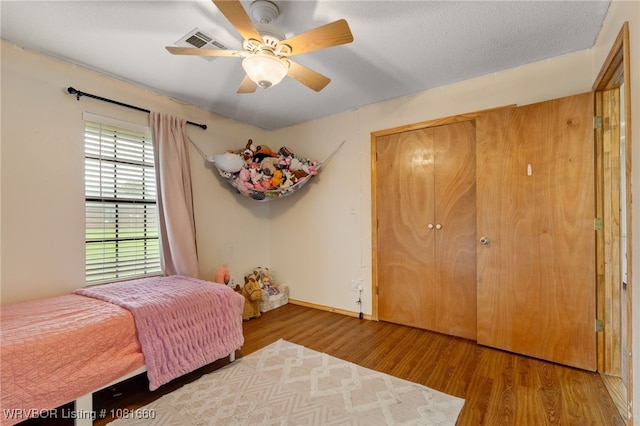 103 Bowlin Dr, Poteau, OK 74953 - bedroom with wood finished floors and ceiling fan