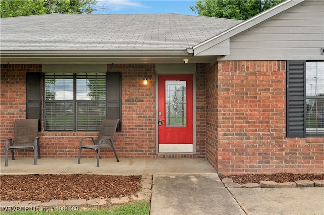 103 Bowlin Dr, Poteau, OK 74953 - entrance to property featuring brick siding, a shingled roof, and a porch