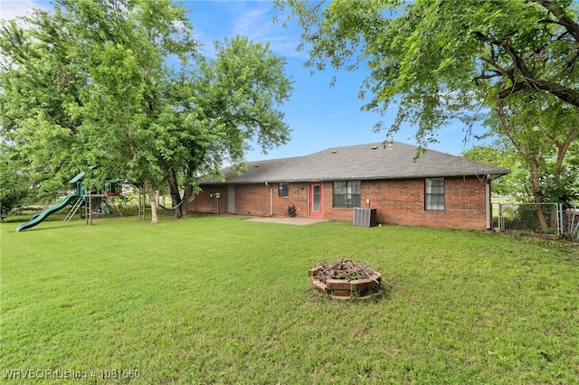 103 Bowlin Dr, Poteau, OK 74953 - back of property featuring a fire pit, a patio area, a playground, and brick siding