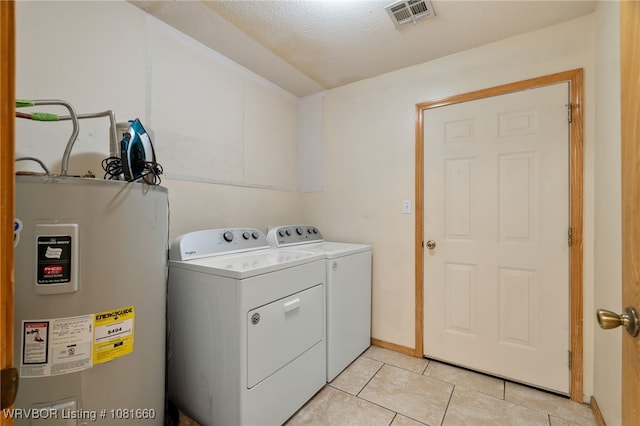 103 Bowlin Dr, Poteau, OK 74953 - laundry room with electric water heater, washer and clothes dryer, light tile patterned floors, and a textured ceiling